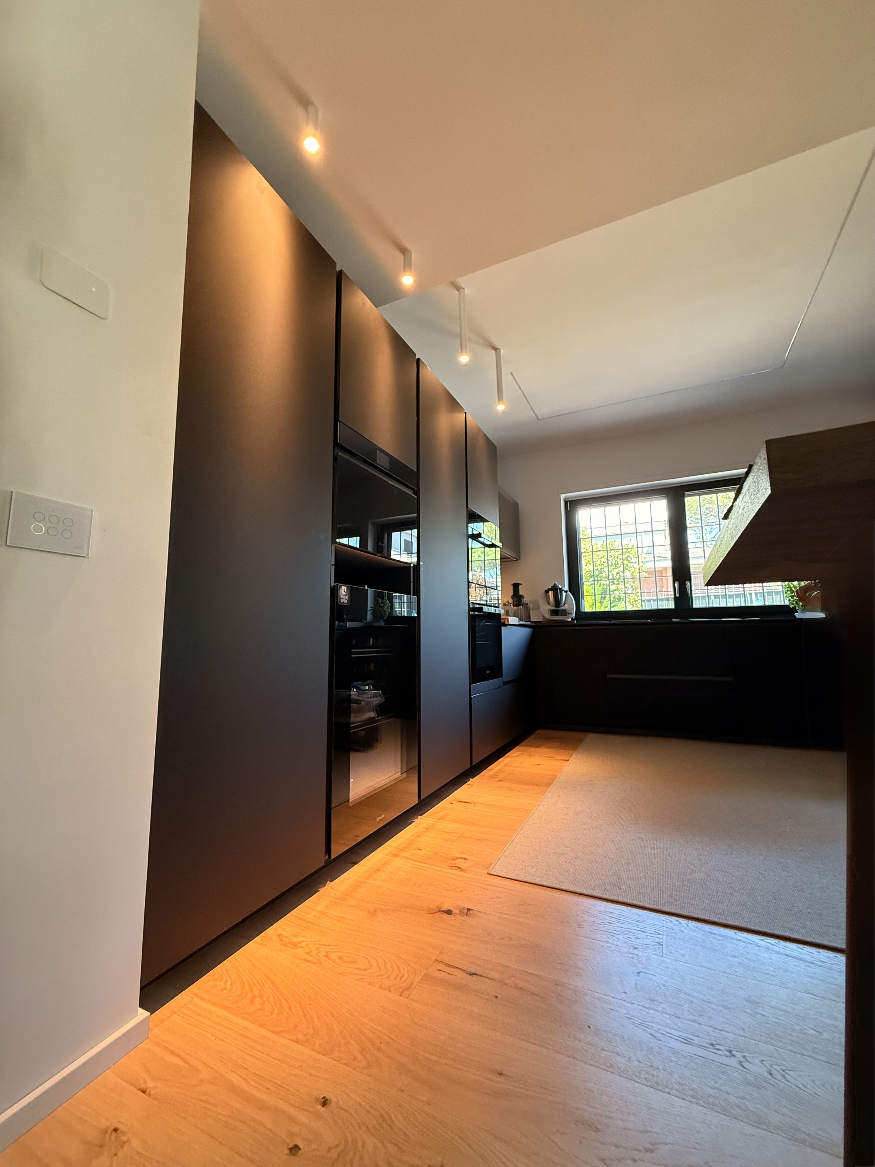 Cucina moderna in finitura nera con pavimento in rovere naturale